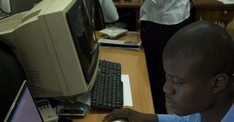 Newsroom team working on laptops